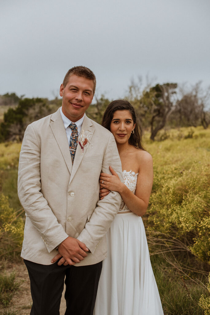 newlyweds posing for outdoor wedding photos
