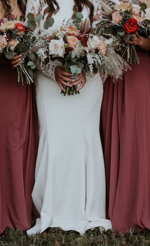 close up of the bride and the bridesmaids dress and bouquet