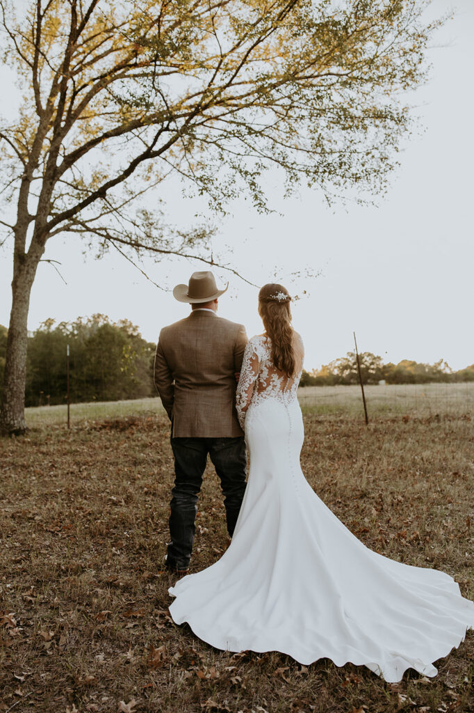 bride and groom looking at a field