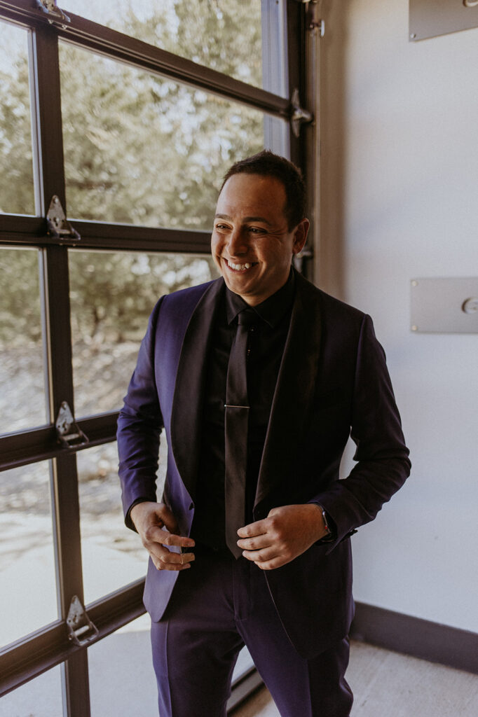 Groom smiling before his ceremony during his photoshoot 