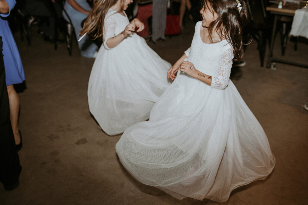 flower girls dancing at the reception 