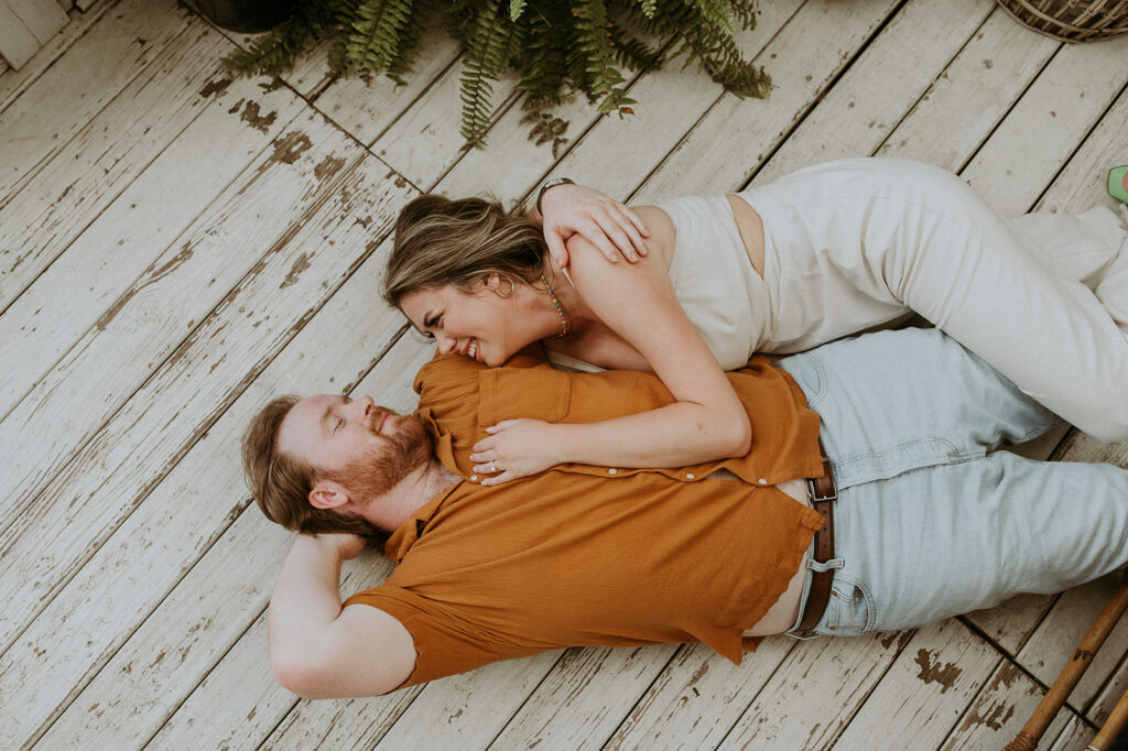 couple laying in the ground during their photoshoot