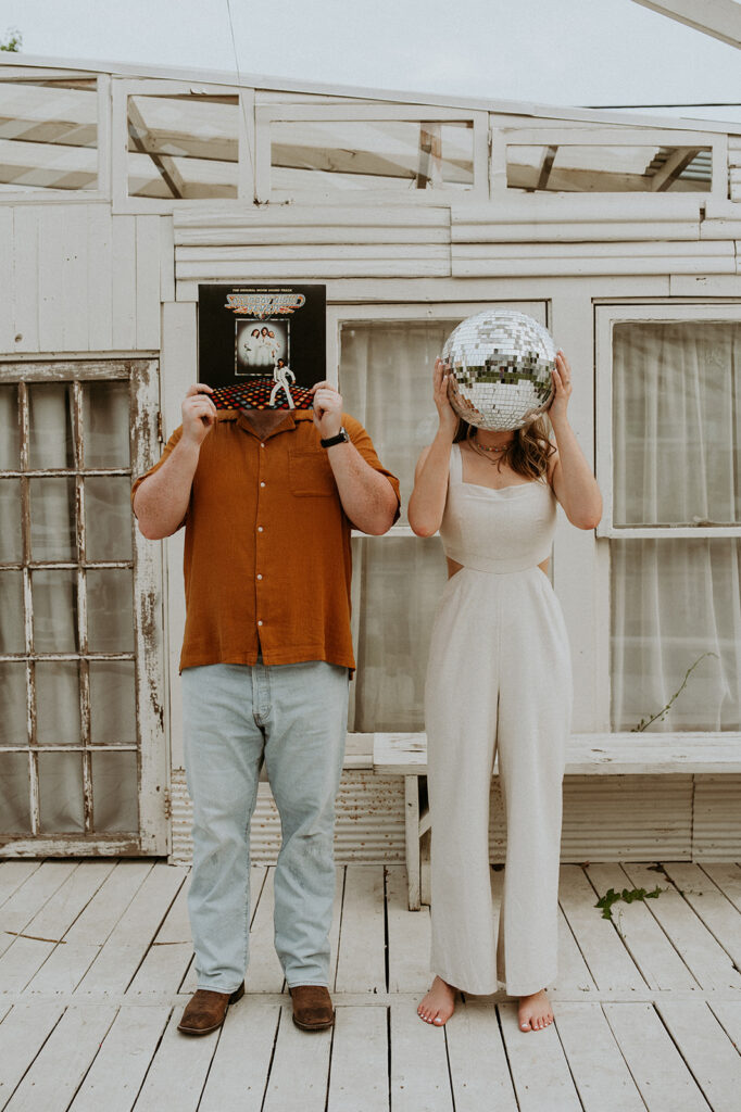 couple with a disco ball and a cd record