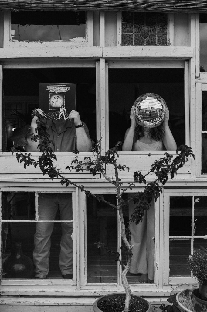 black and white picture of a couple with a disco ball and cd record