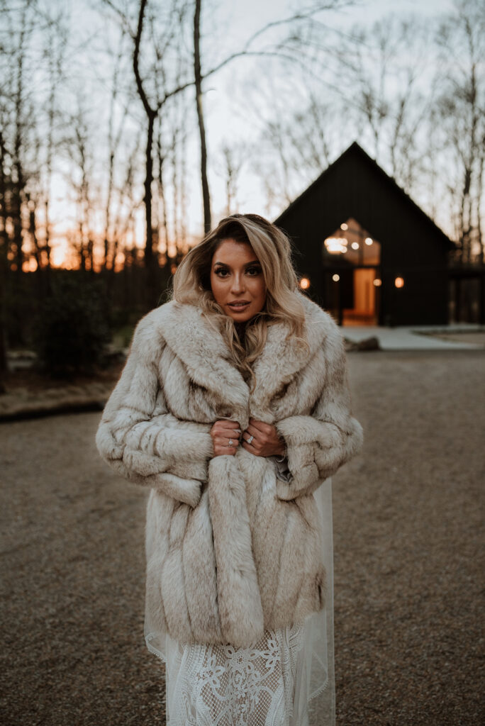 bride wearing a beautiful coat during her winter elopement day
