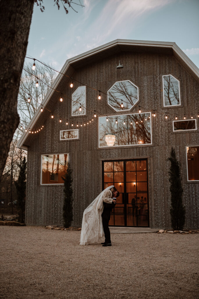 Groom Carrying the bride at dove hollow estates during their romantic winter elopement