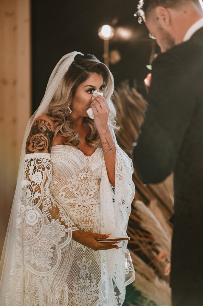 bride emotional when exchanging vows at the altar during their winter Texas elopement 