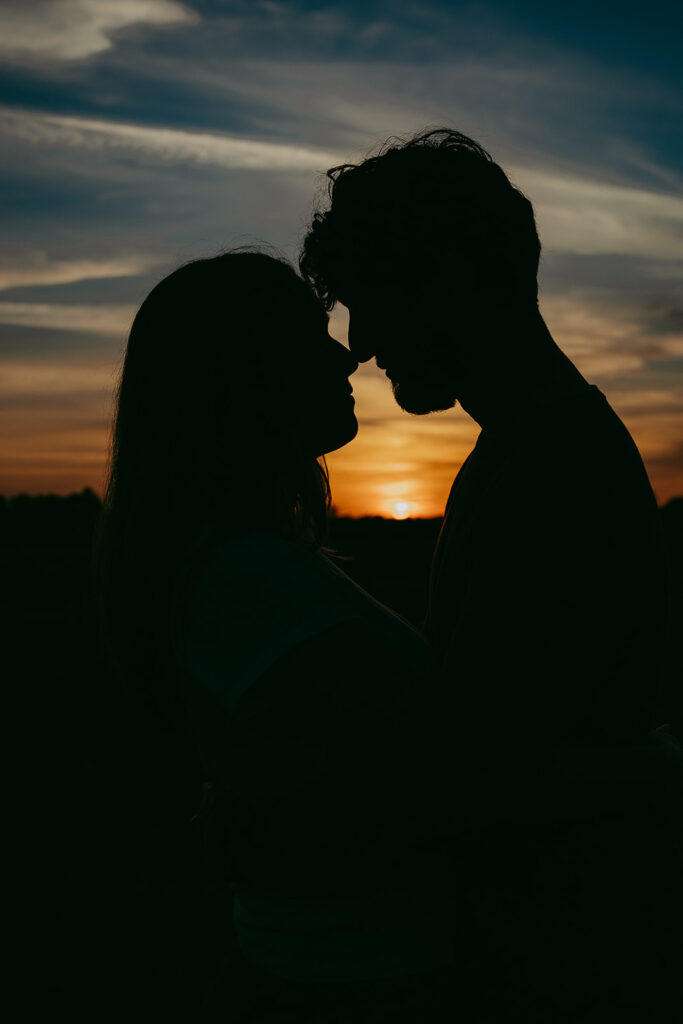 couple looking at each other with the sunset in the background
