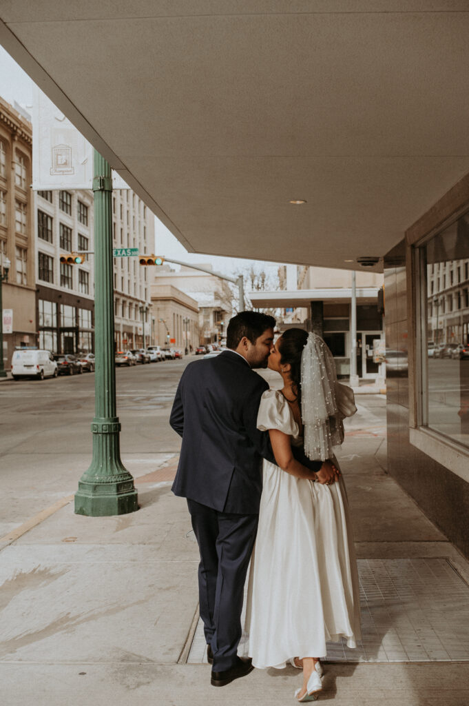 couple kissing and holding hands at downtown el paso