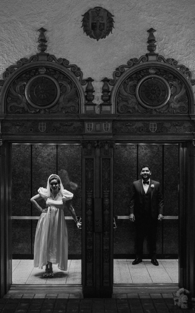 black and white photo of the couple in an elevator