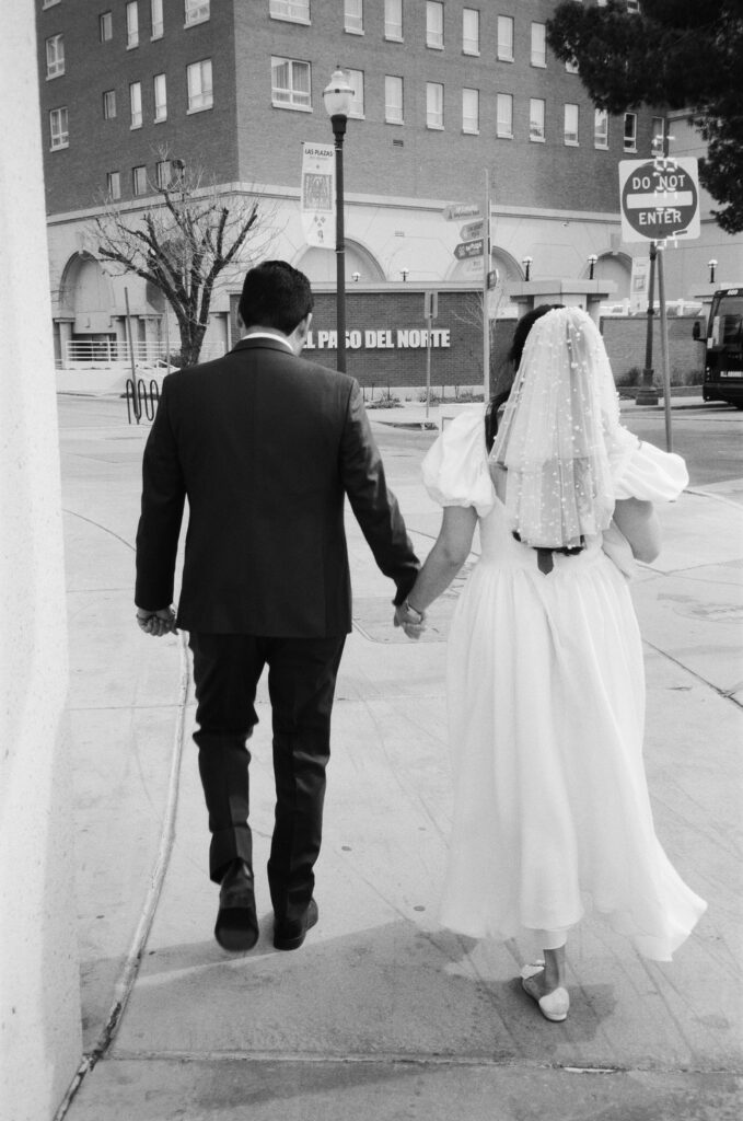black and white couple walking holding hands