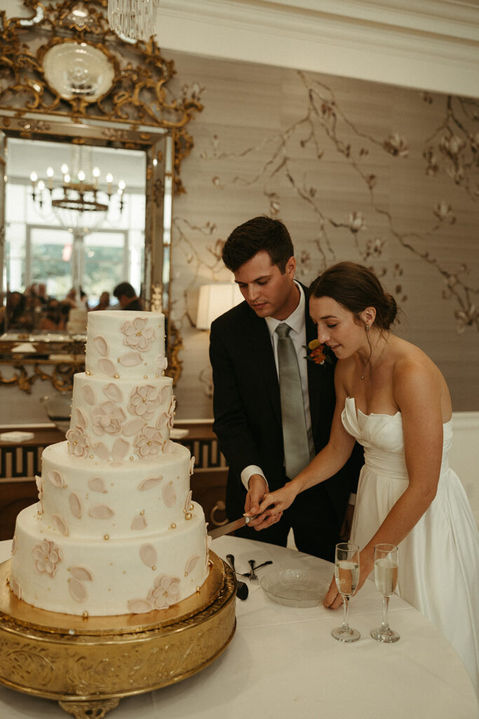 couple cutting their stunning wedding cake