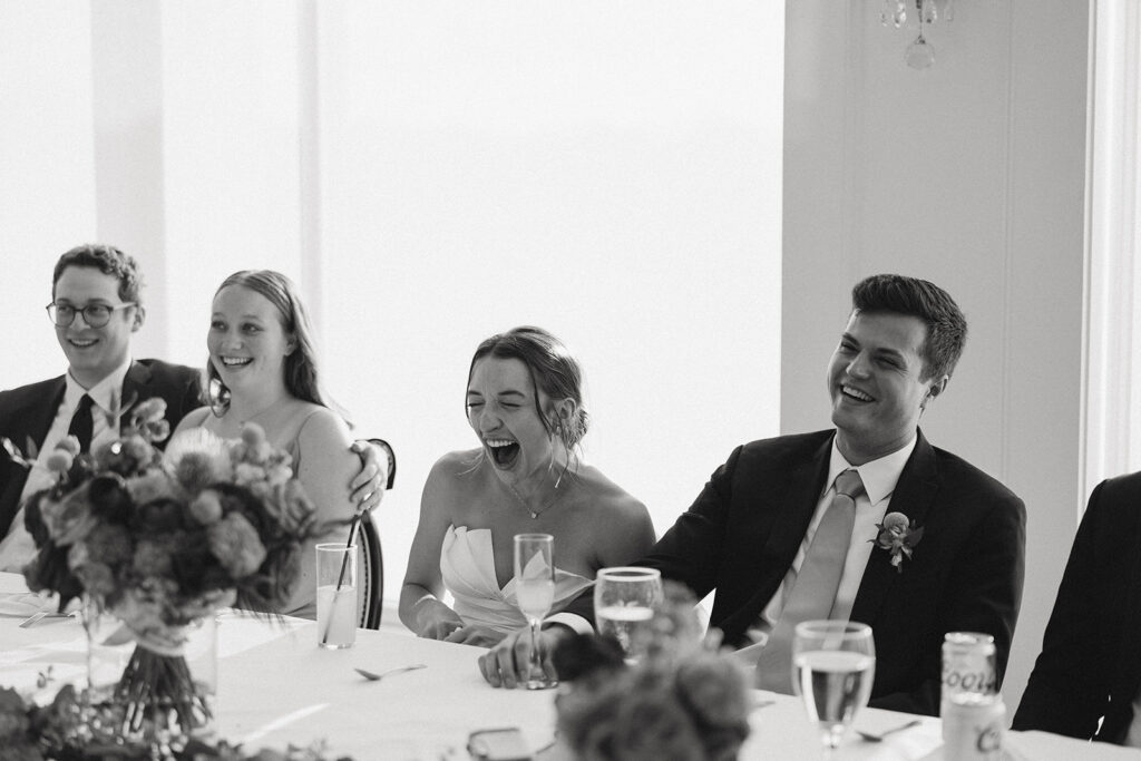 bride and groom laughing at their wedding reception