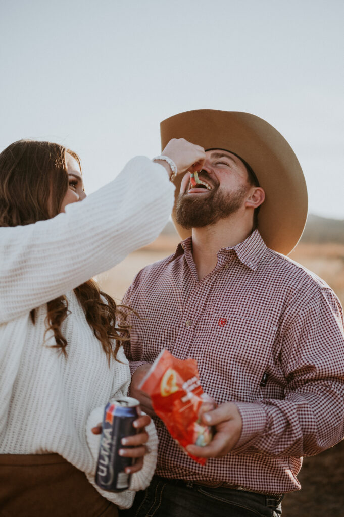 couple eating snacks at their engagement session 