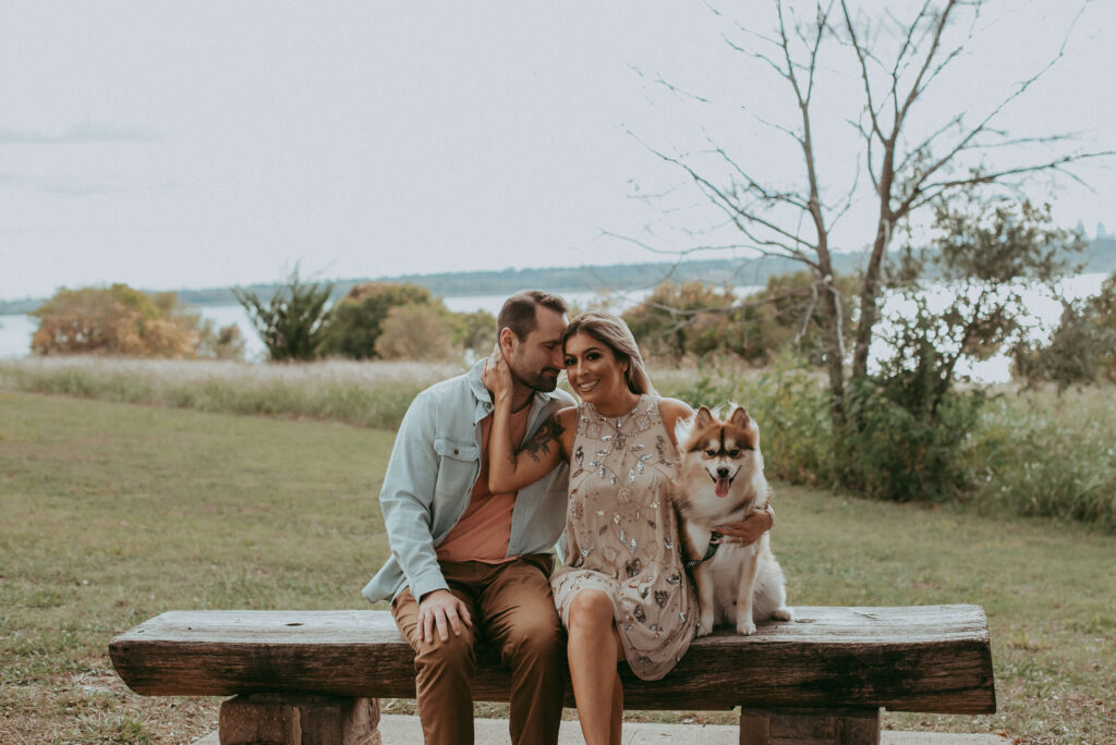couple sitting at the park with their dog