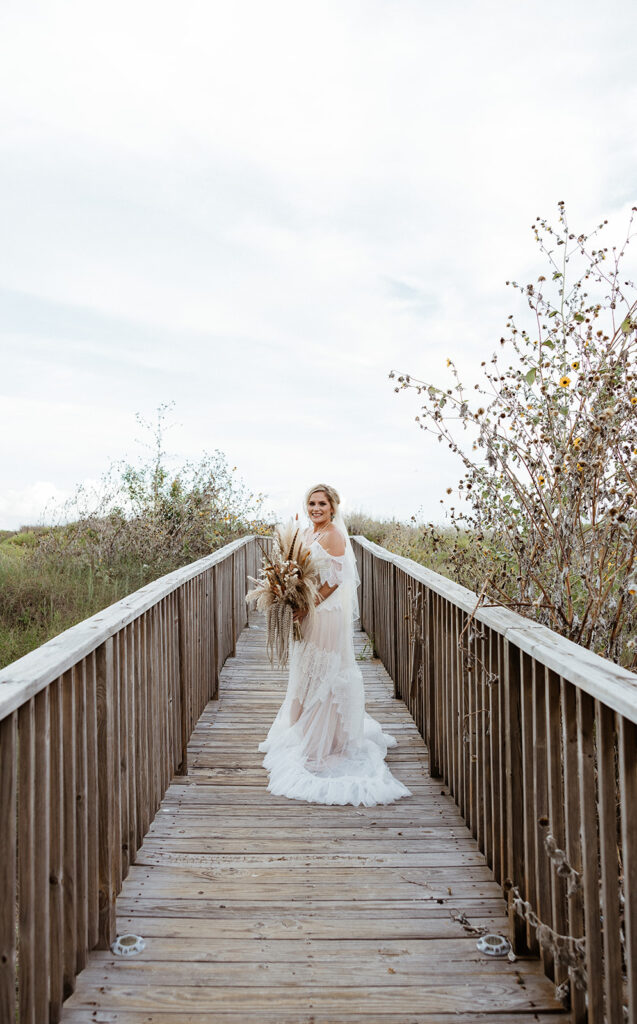 bride walking to the ceremony location at her texas coast wedding 