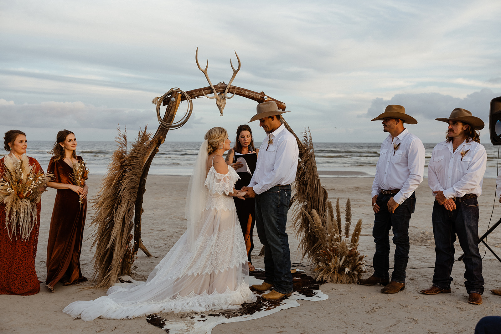 couple holding hands during their texas coast wedding ceremony