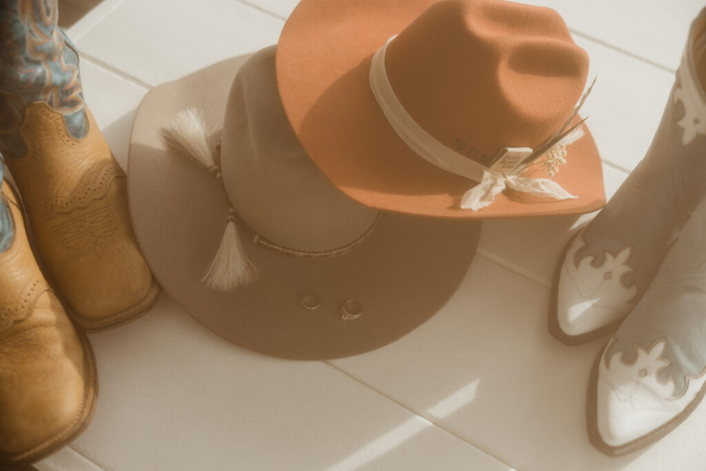 cowboy hats the bride and groom wore for heir intimate beach wedding 