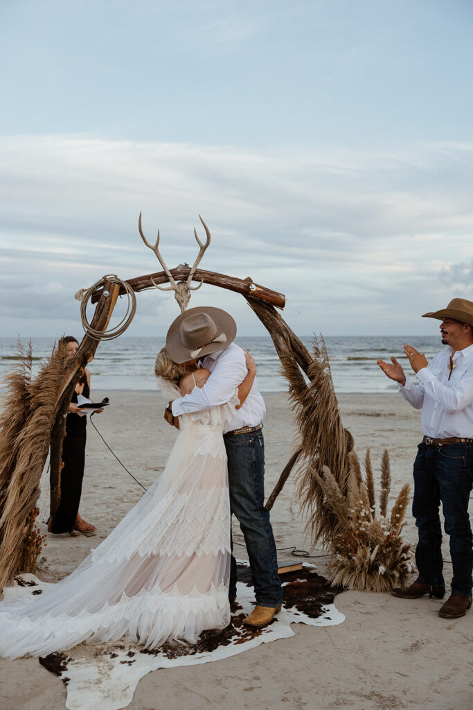 bride and groom kissing after their texas coast wedding ceremony 