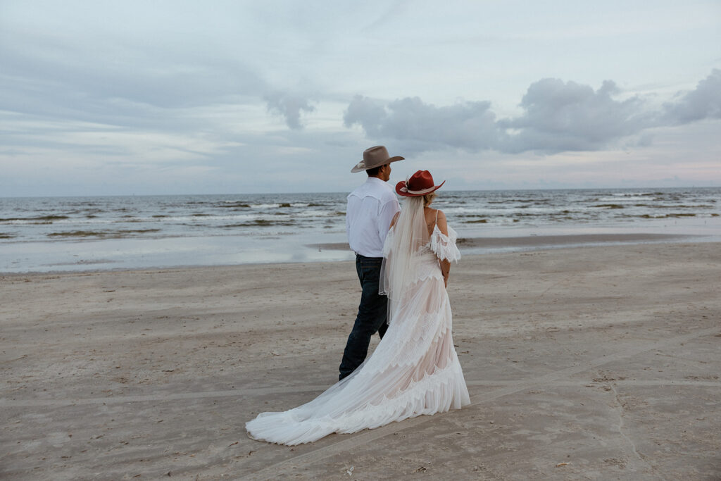 bride and groom walking around the beach after their intimate texas coast wedding ceremony