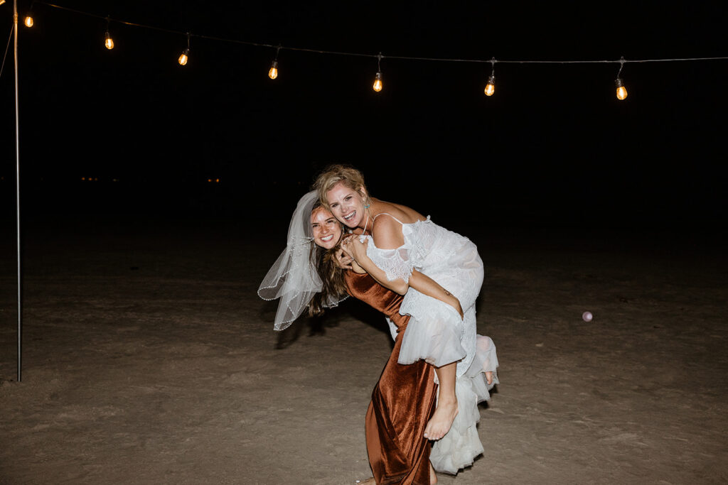 bride and her bridesmaid dancing at her texas coast wedding