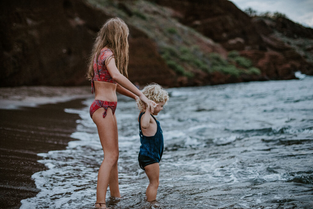 children playin at the beach in maui during their photoshoot 
