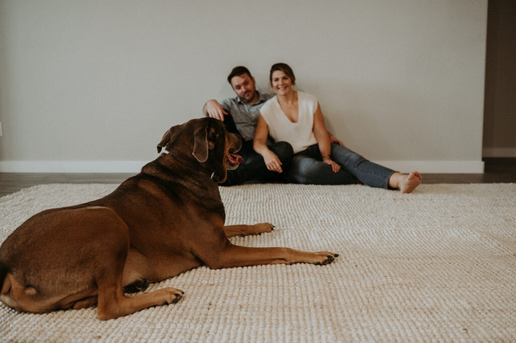 happy couple with their dog at their new house 
