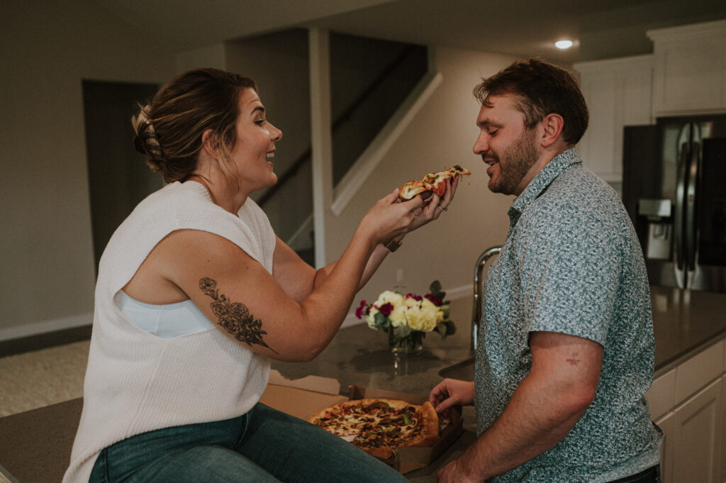 couple eating pizza at their first home | at home couples session