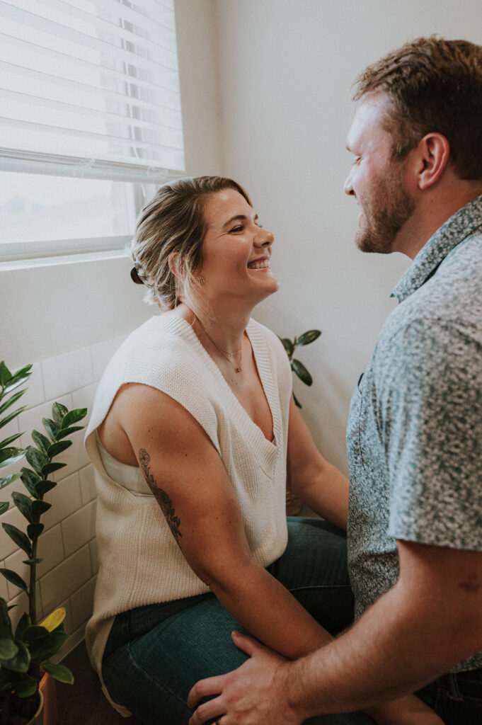 couple laughing during their first home photoshoot