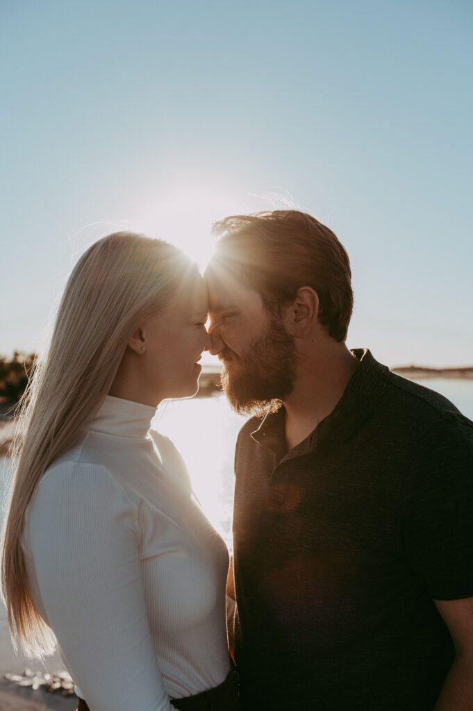 portrait of the couple at their adventurous engagement session with the sun in the background
