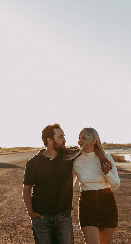 portrait of the newly engaged couple at their adventurous engagement session. during golden hour 
